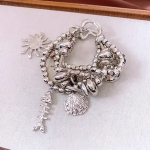 Vintage multilayer silver beaded bracelet with sun, fish bone and shell charms