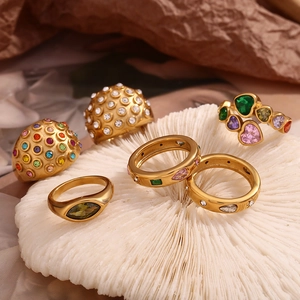 Group of 18K gold plated stainless steel rings with colorful zircon on white coral