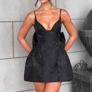 Elegant black mini party dress featuring deep V-neck and large back bow detail