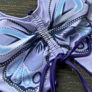 Purple butterfly print bikini top with adjustable drawstring and slim tie straps