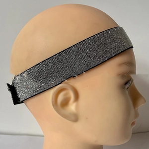 Detail of silver reflective wig headband with adjustable hook and loop closure design