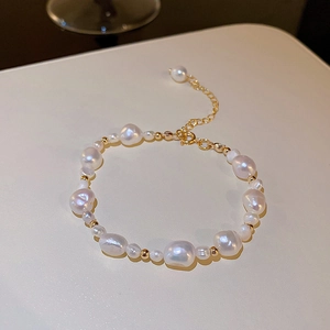Detail of baroque pearl bracelet with gold beads and adjustable lobster clasp closure