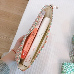Detailed view of the large floral cotton makeup bag with metal zipper and interior space