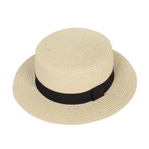 Close-up of beige woven straw boater hat featuring a wide black ribbon trim and fine texture