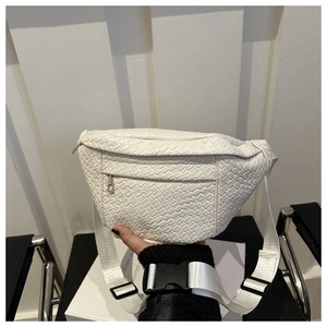 Detail of white woven texture fanny pack featuring adjustable strap and buckle closure