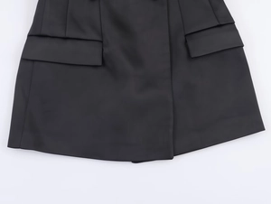 Dettaglio della giacca da abito in raso nero con tasche a patta e cuciture di alta qualità