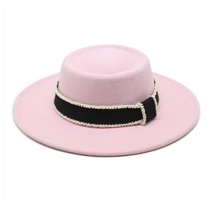 Detail of light pink wool felt hat with black grosgrain ribbon and pearl bead trim