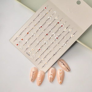 Minimalist flower nail art stickers with red rhinestones and white floral vine designs