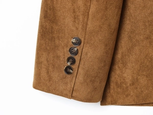 Detailed close-up of brown suede blazer cuffs with four tortoiseshell buttons decoration
