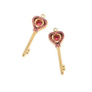 Golden heart key pendant with red center stone and pink crystals on white background