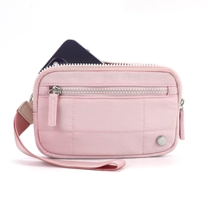 Detailed view of pink quilted card holder with wristlet strap and phone storage space
