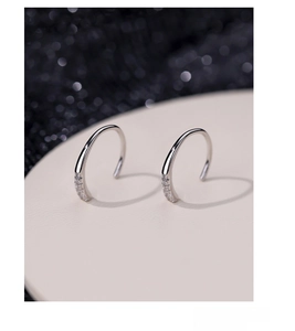 Macro shot of S925 sterling silver hoop earrings featuring tiny inlaid zircon crystals