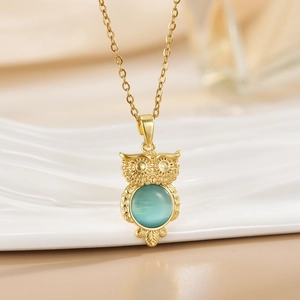 Golden owl pendant necklace with blue-green opal stone inlay and delicate metal carving