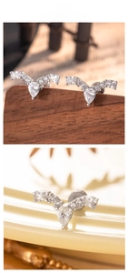 Detail of silver V-shaped earrings with pear-cut cubic zirconia and screw-back closure