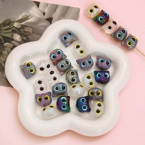 Colorful acrylic owl beads for DIY bracelets displayed in a star-shaped ceramic tray