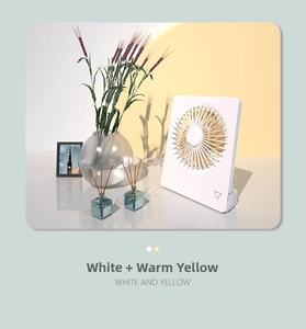 Detail of white desktop USB fan with warm yellow grill and modern minimalist design