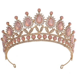 Detailed view of bridal crown featuring pink teardrop gems and white crystals in gold alloy