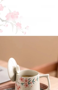Detailed macro view of hand-painted peach blossom ceramic mug with lid in ash glaze finish