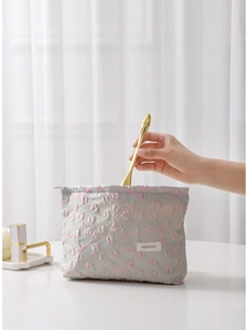 Floral relief makeup bag in grey with pink blossoms for daily student storage