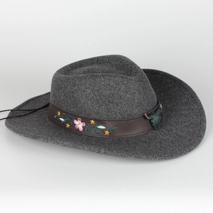 Close-up of dark grey wool felt fedora featuring floral embroidery and bronze bull buckle