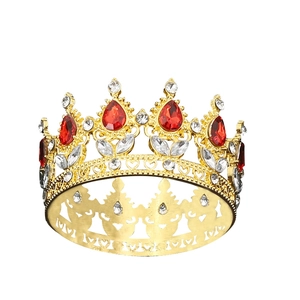 Golden Baroque bridal crown with red pear-cut gems and sparkling crystals on white background