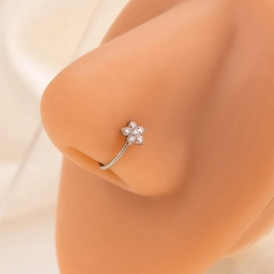 Close-up of a silver floral nose ring with small diamonds on a model's nose