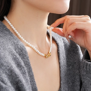 Close-up of vintage oval pearl necklace with zircon details on a model's neck