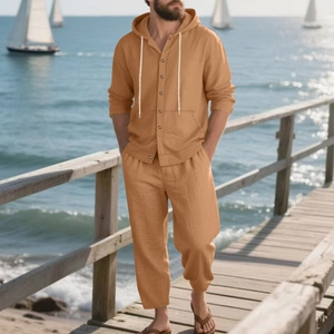 Detail of ochre men's linen beach set showing button-up hooded shirt and drawstring pants
