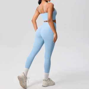 Close-up of light blue seamless yoga set with thin straps and high waist compression leggings
