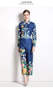 Detailed close-up of floral print satin fabric on the long sleeve shirt and trousers set