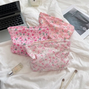 Detailed close-up of quilted floral cosmetic bags set against a lifestyle background