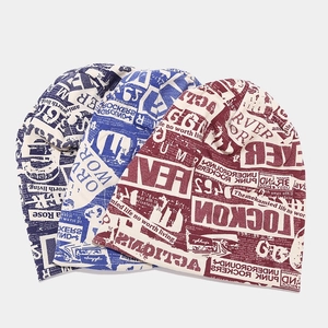 Set of three vintage-style knit beanies with artistic newspaper letter prints in various colors