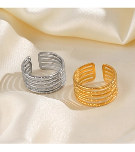 Detail of 18K gold and silver plated five-layer adjustable rings with hammered texture