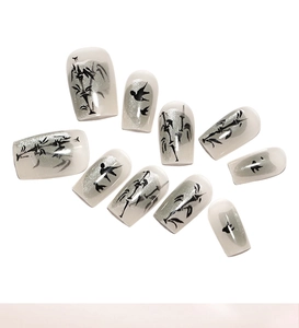 Detailed ink wash bamboo and bird pattern on cat-eye finish press-on nails