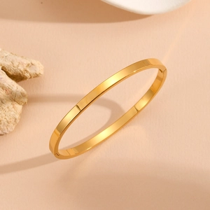 Detailed 45-degree angle view of high-gloss gold minimalist stainless steel open bangle