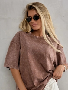Close-up of brown acid wash texture and cotton fabric on oversized vintage t-shirt