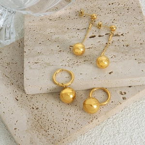 18k gold plated stainless steel ball earrings and hoop dangles on beige stones