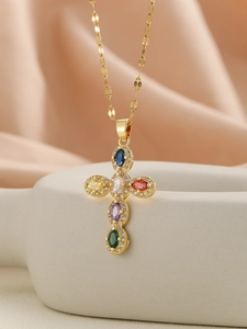 Detail of a gold cross pendant necklace featuring vibrant multi-colored zirconia stones