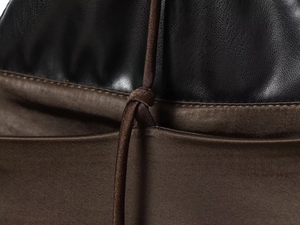 Macro shot of black leather stitching with deep brown satin fabric and matching drawstring