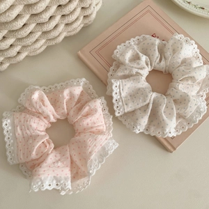 Detail of pink and blue polka dot cotton scrunchies with delicate white lace edges