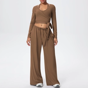 Détail de l'ensemble de yoga marron avec haut cache-cœur et pantalon taille haute à jambes larges