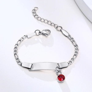 Detail of silver stainless steel Figaro bracelet with red birthstone and ID plate