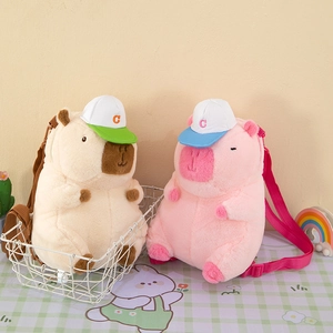 Detail of plush capybara and pig backpacks with adjustable straps and cute lettered caps