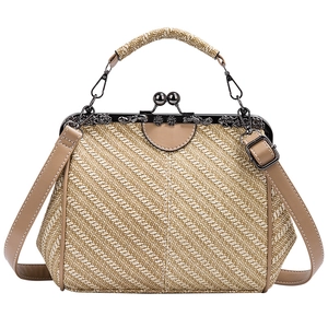 Close-up of vintage beige woven handbag with embossed metal floral clasp and leather handle