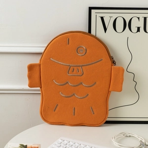 Detail of cute fish-shaped laptop sleeve with embroidery and orange felt material