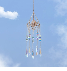 Detail of geometric golden suncatcher with natural gemstone and hanging crystal prism