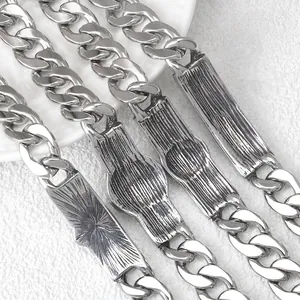 Back view of silver curb chain bracelets showing textured stainless steel metal plates
