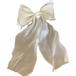 Elegant cream white satin bow hair claw clip with long flowing ribbons on white background