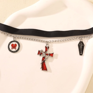 Detail of gothic choker with coffin, bloody heart, and cross pendants on black ribbon