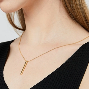 Modern gold bamboo style necklace for women with minimalist cylindrical diamond pendant